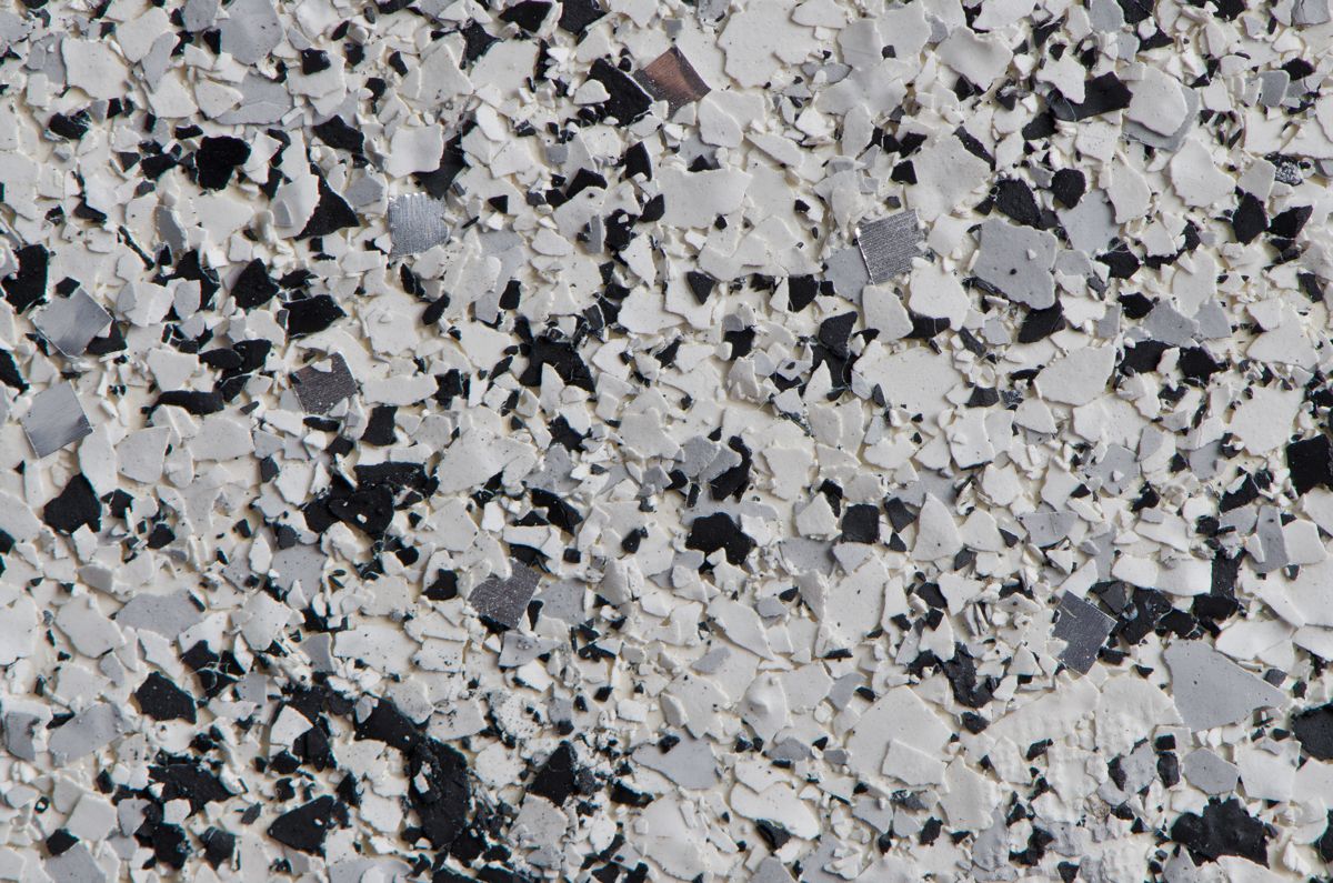 Close-up of a gray, black and white flake epoxy floor